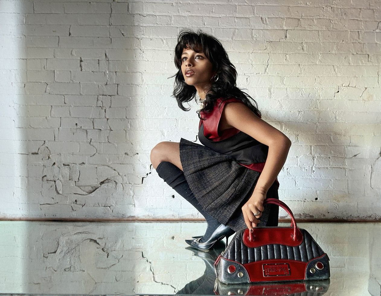 A picture of Tanya Ravichandran with a red dior bag.